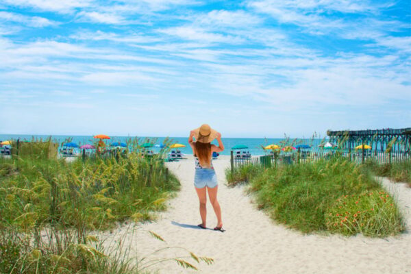 Woman walking towards the beach, Myrtle Beach, South Carolina